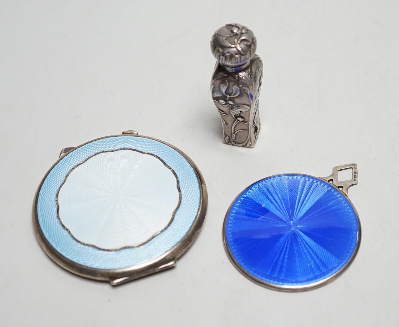 A 1930's silver and enamelled hand bag mirror, London, 1930, 52mm, together with a silver and enamelled compact and a small white metal scent bottle.